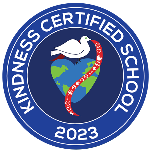 A blue circle with the words kindness certified school 2023 written in white font around the edges of the circle and a dove holding a red banner in its mouth and sitting on a heart-shaped planet Earth in the center of the circle