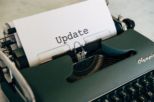 typewriter with a paper with the word, "update" typed on it